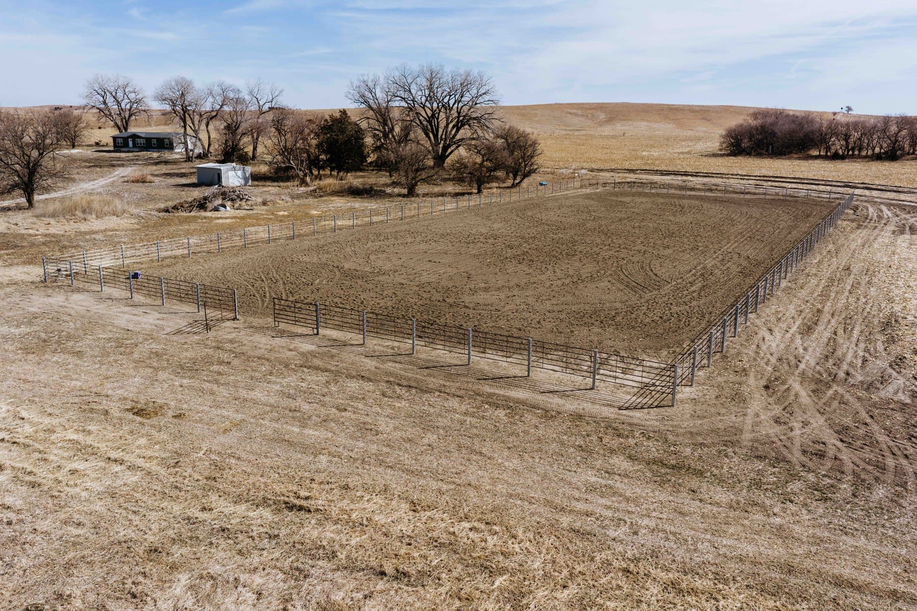 Aerial view of a steel corral system laid out on working ground.
